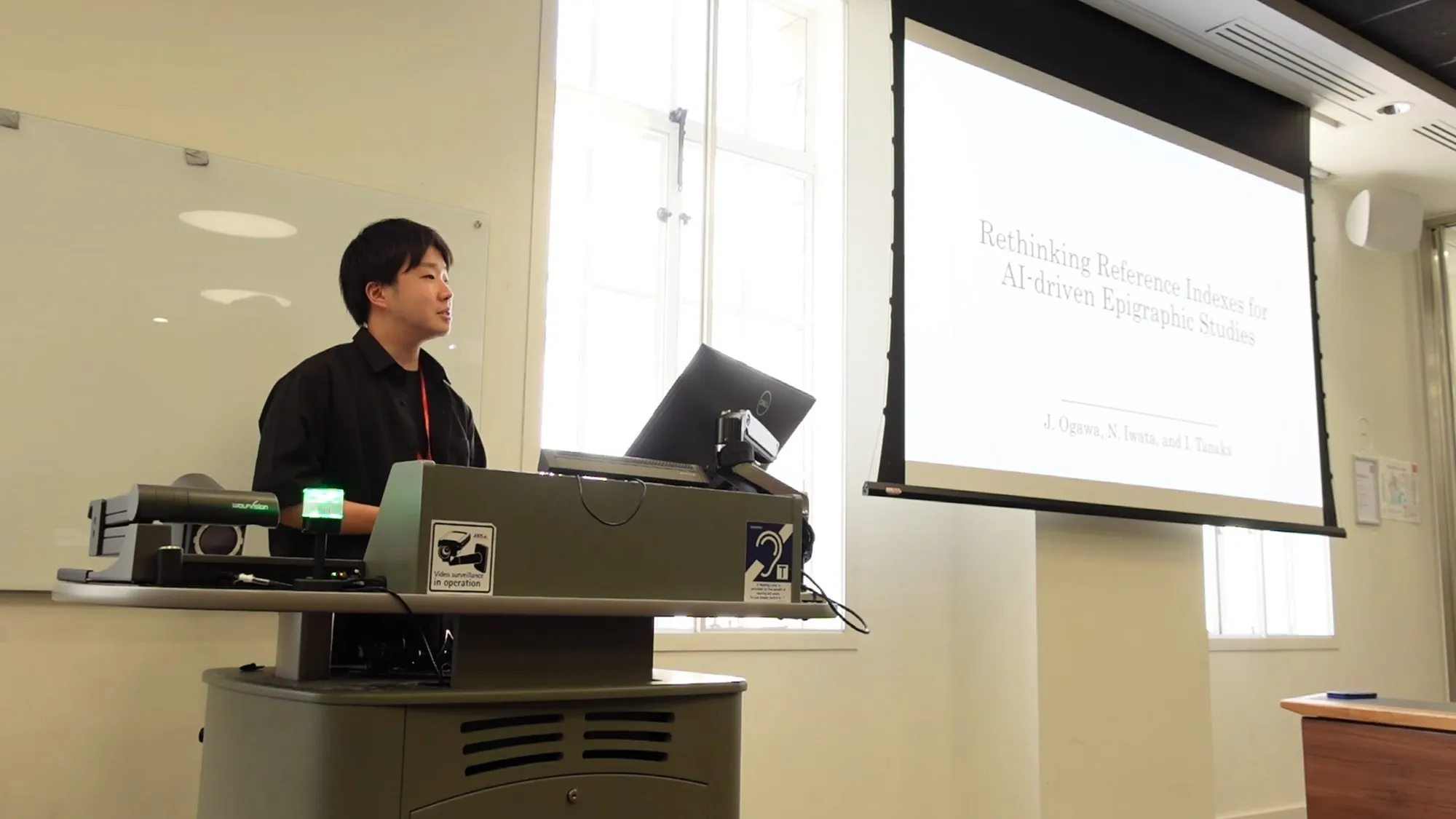 Jun Ogawa presenting in front of his title slide
