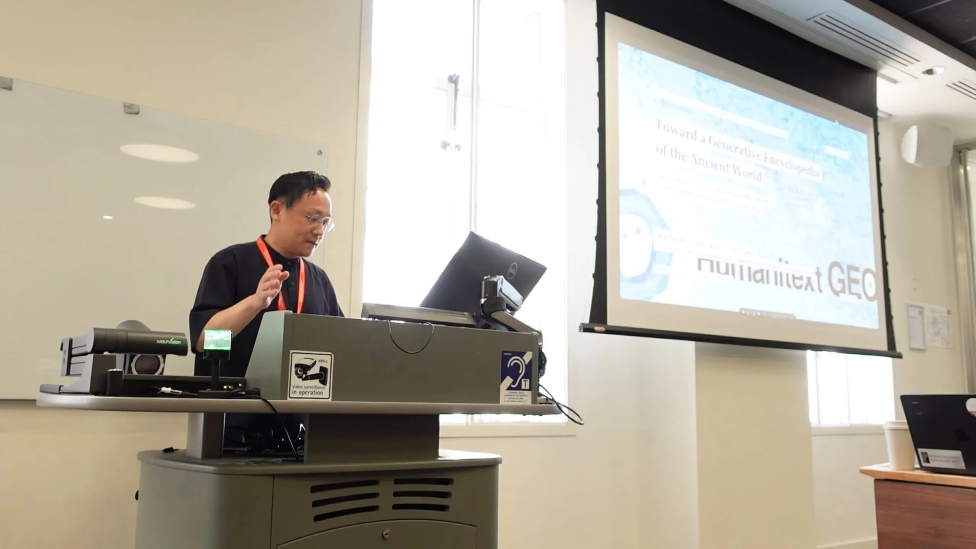 Ikko Tanaka presenting with the Humanitext GEO slide