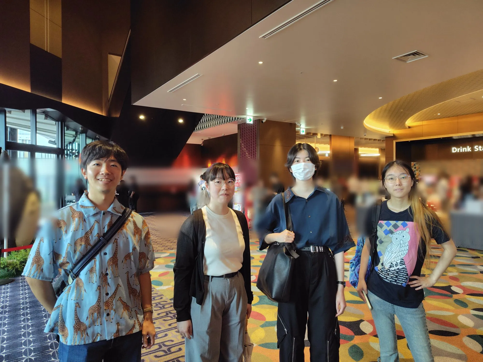 Four members of Humanitext in the theater foyer at the advance screening