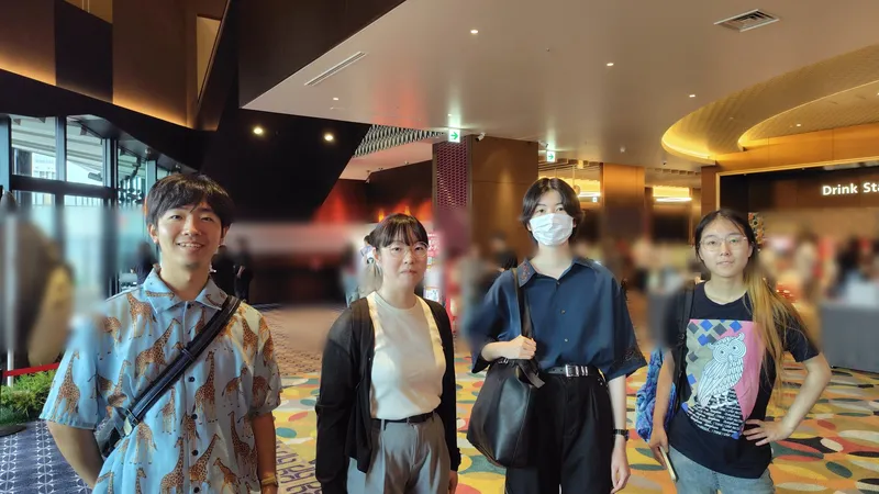 Four members of Humanitext in the theater foyer at the advance screening