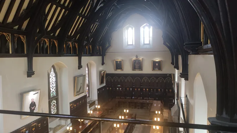 The dining hall of Merton College, Oxford, lined with portraits and long tables